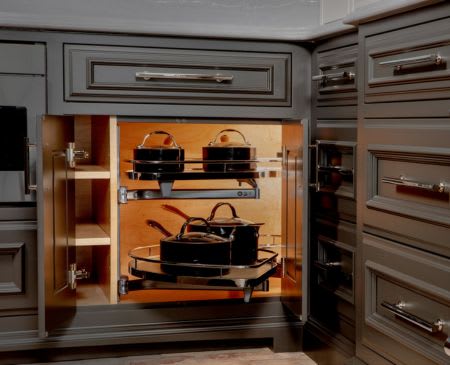 Close up of lower kitchen cabinets with backlit corner le mans storage organizer