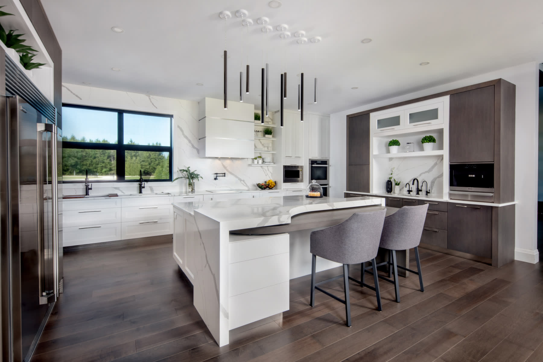A modern custom kitchen with a grey stained rift white oak and white painted maple cabinets.