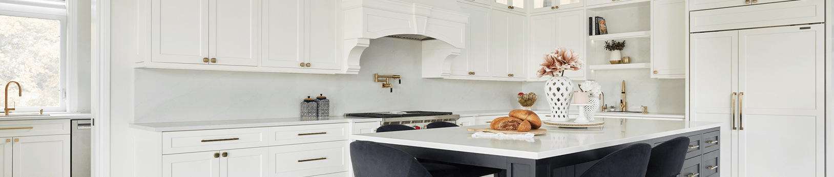 white traditional custom kitchen design with white cabinetry and a marble countertop island with black cabinets
