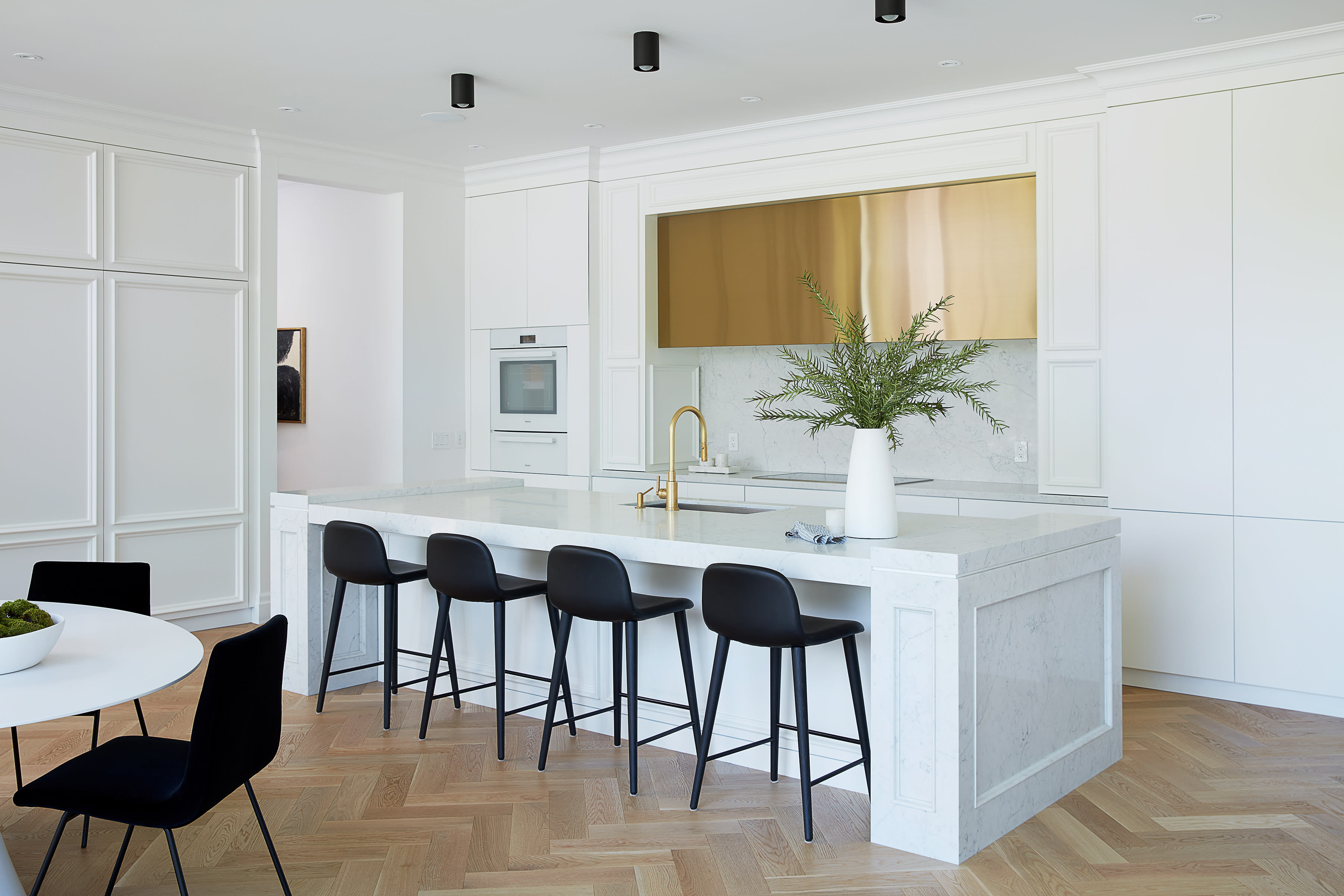 classic luxury white kitchen with brass range hood