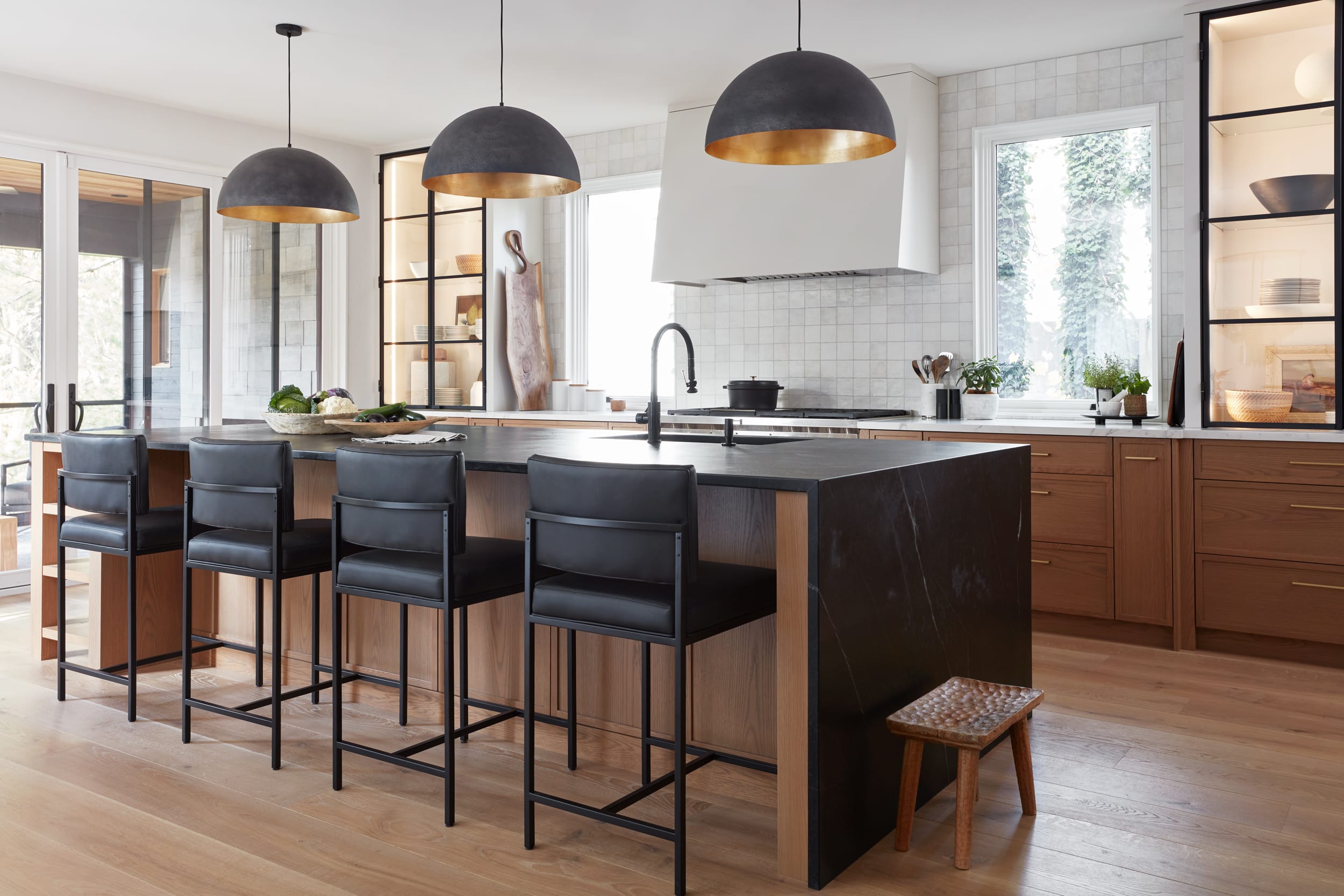 Overview of the kitchen space looking towards the waterfall island and rift white oak cabinets