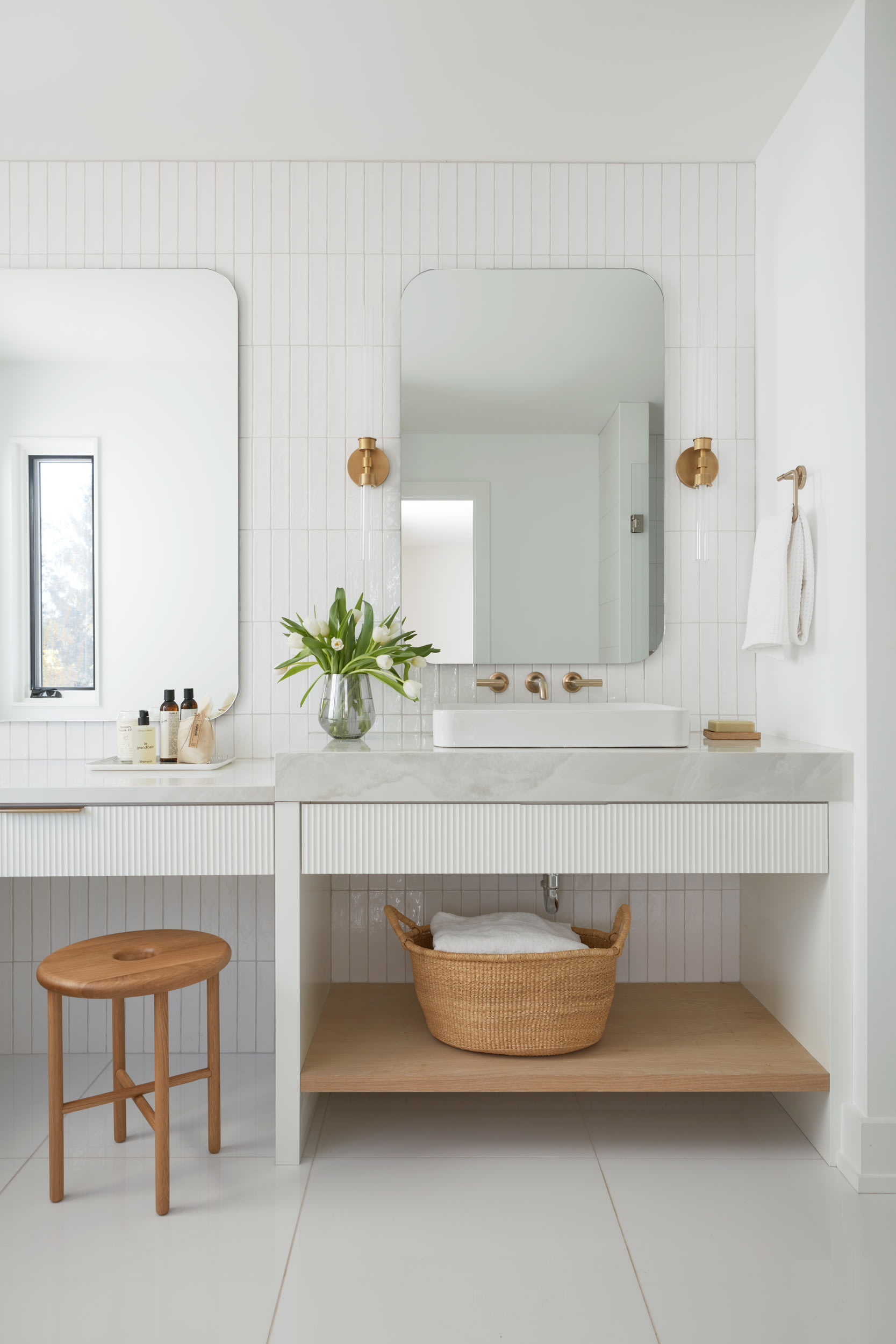 A chic vanity with white fluted doors