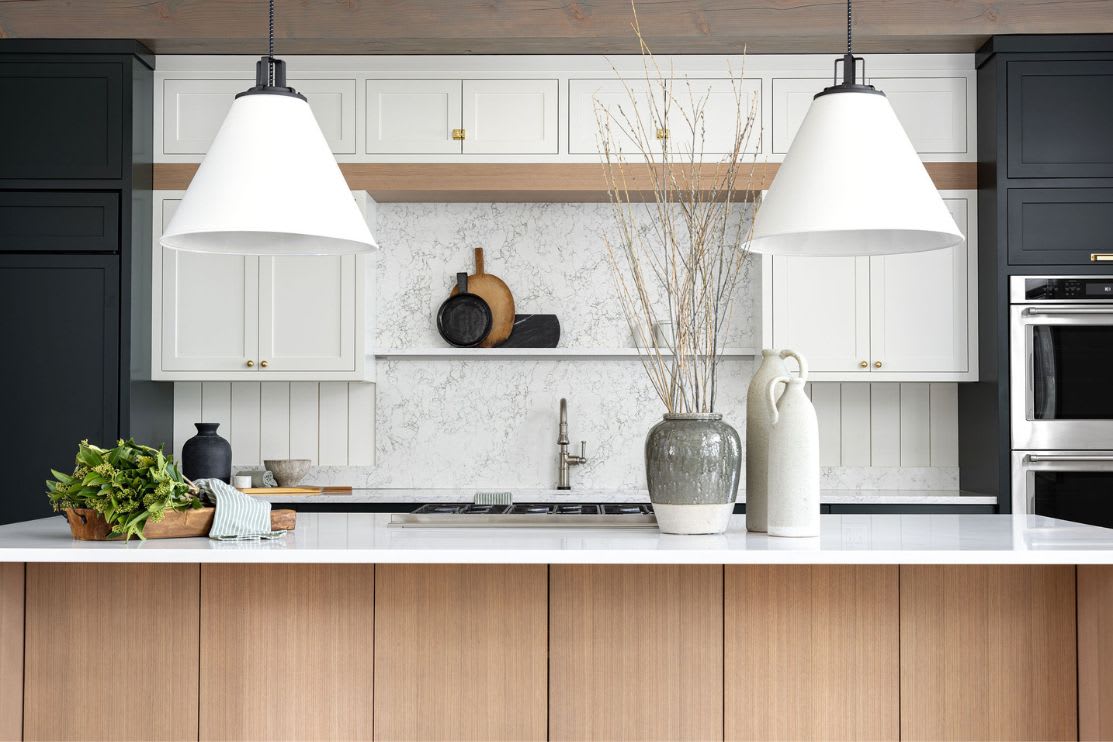 Close up of white oak kitchen island with painted grey cabinets