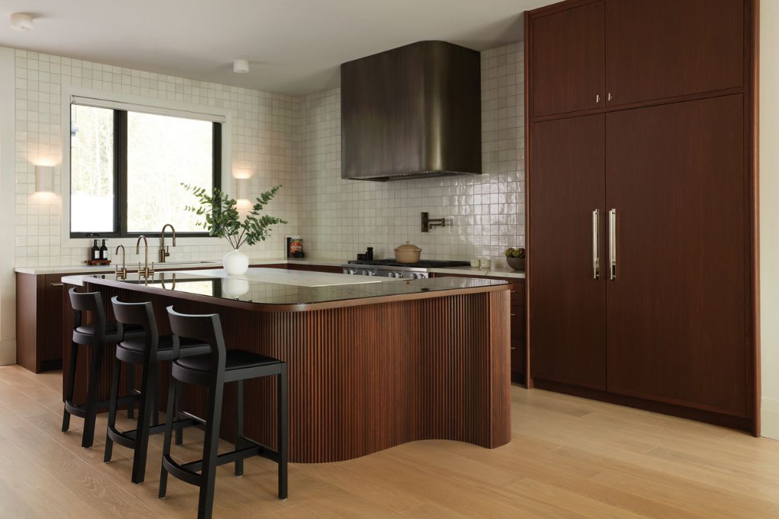walnut kitchen with curved island and modern accents