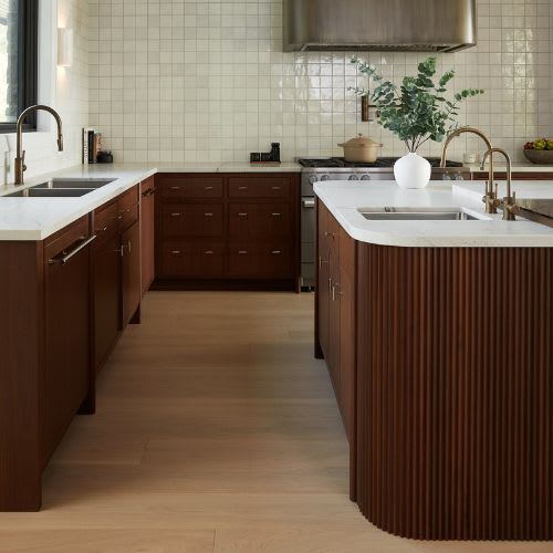 overview of countertops and walnut cabinets in modern kitchen