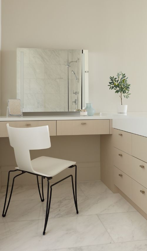 A custom built bathroom vanity in white oak with ample storage compartments