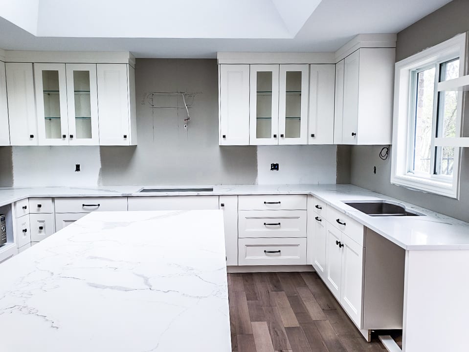 white kitchen with grey and white countertop