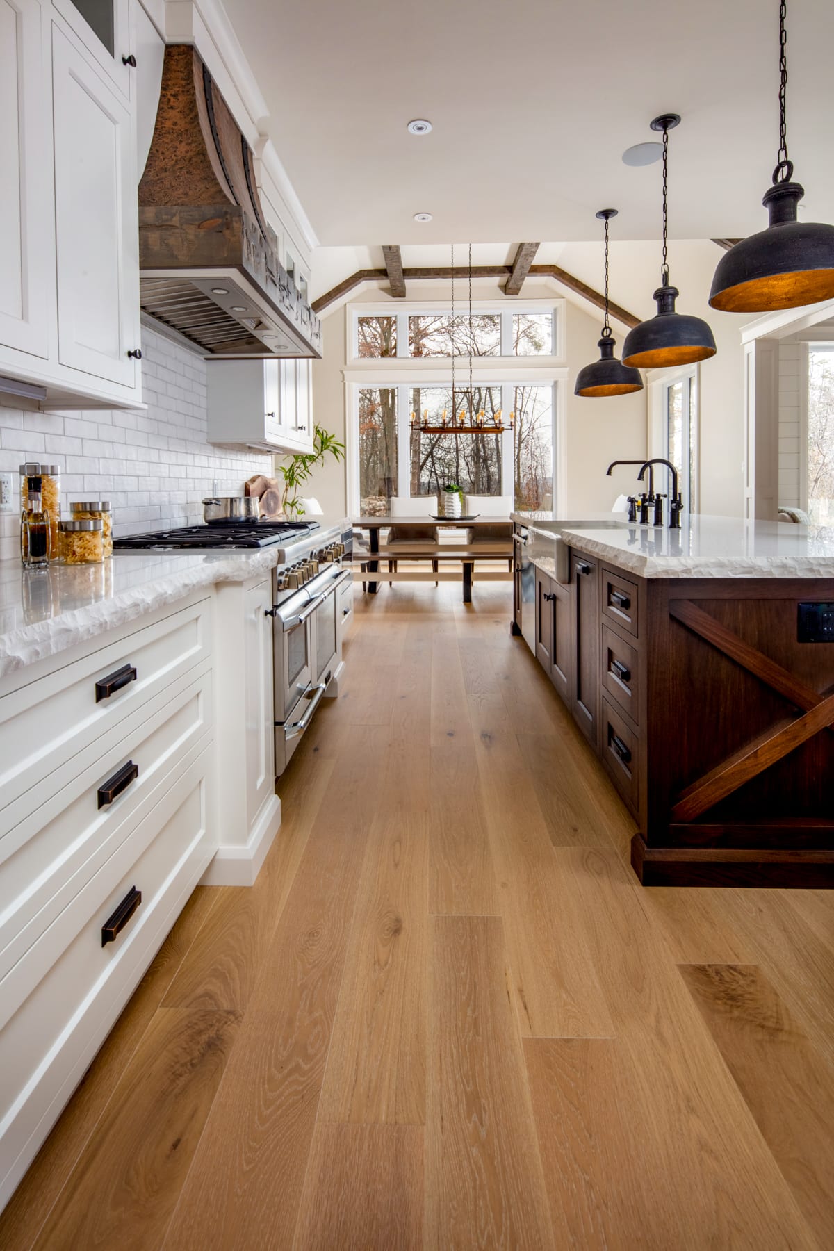A traditional kitchen with white cabinetry and rustic details