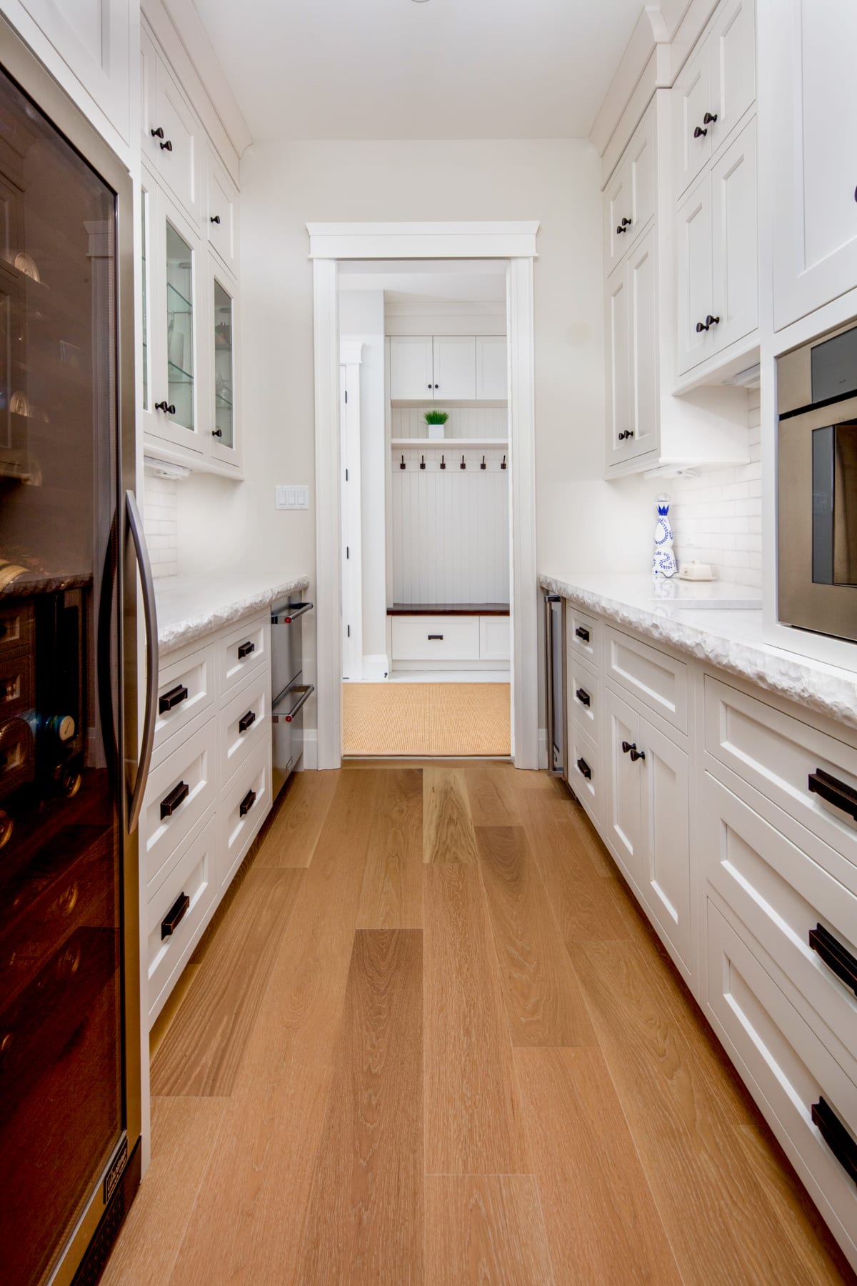 A traditional butlers pantry with white cabinetry and rustic details
