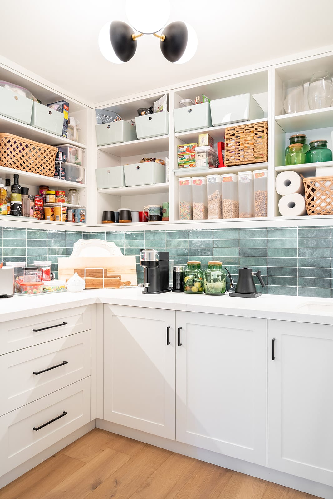 White pantry with open shelving and blue tile backsplash