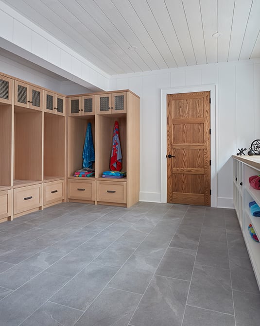 white rift oak cabinetry in mudroom with open shelves to store towels.