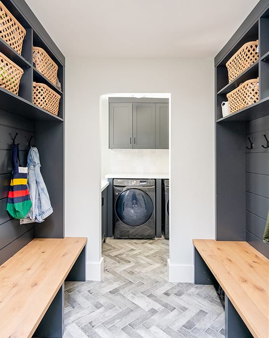 black and wood stained cabinetry in mudroom on both sides of the walls