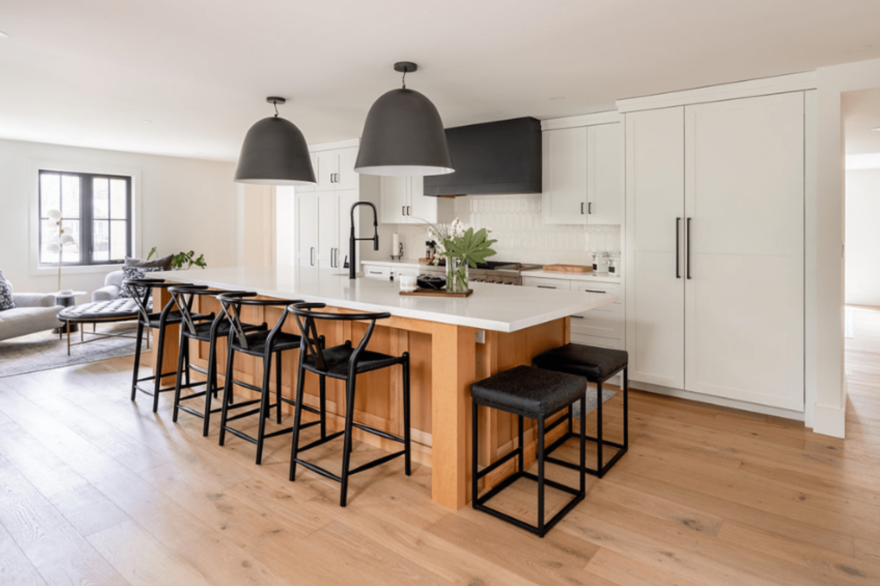 A transitional kitchen design created with stained alder wood and painted white cabinetry. 