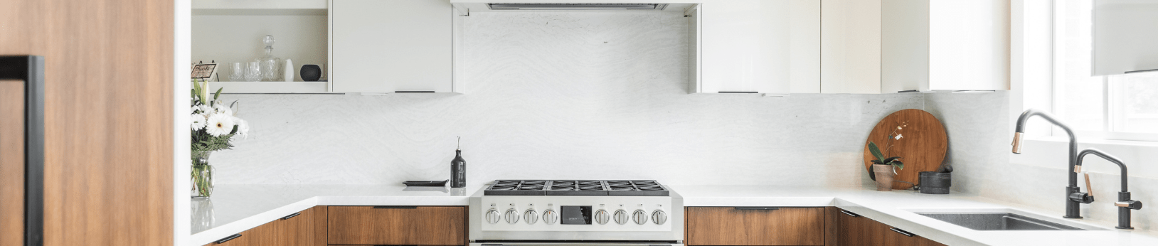 Contemporary kitchen with walnut wood, high gloss white upper cabinets and light quartz countertops