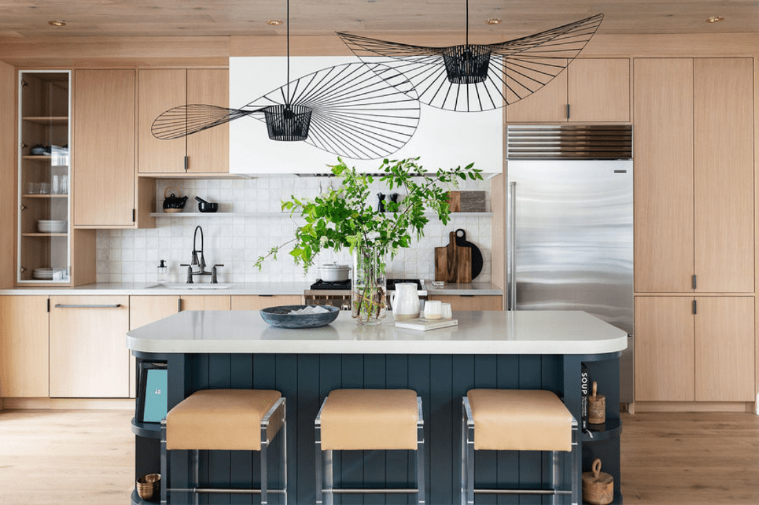 Blue paneled curved cottage kitchen island with open shelving