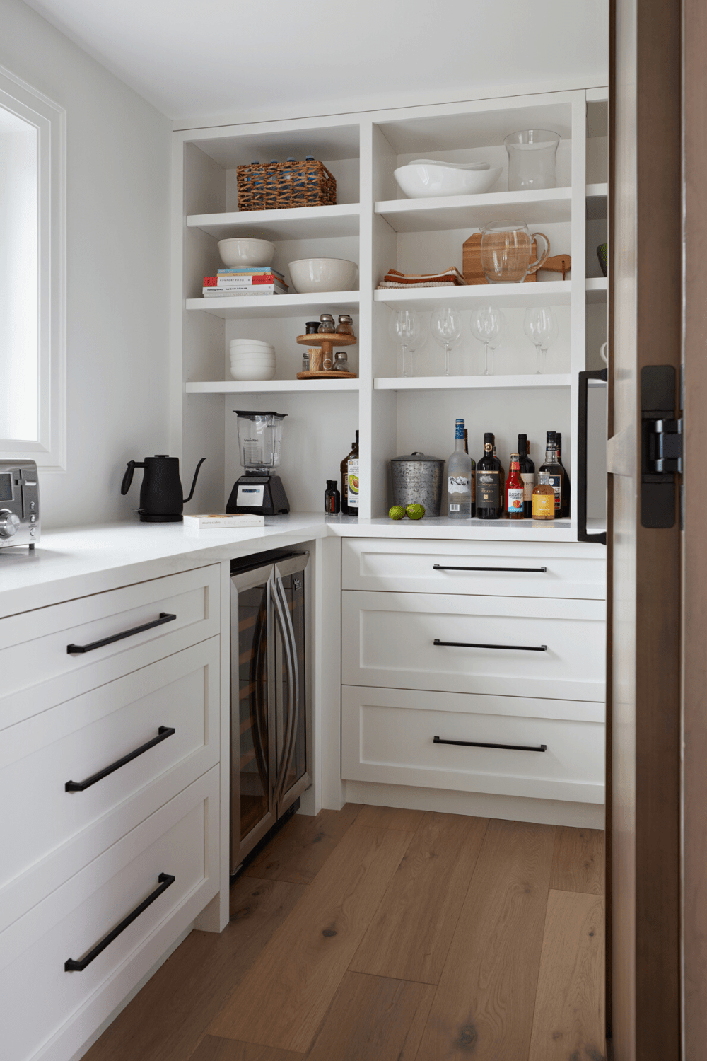 medium-toned stained maple kitchen with white hidden pantry