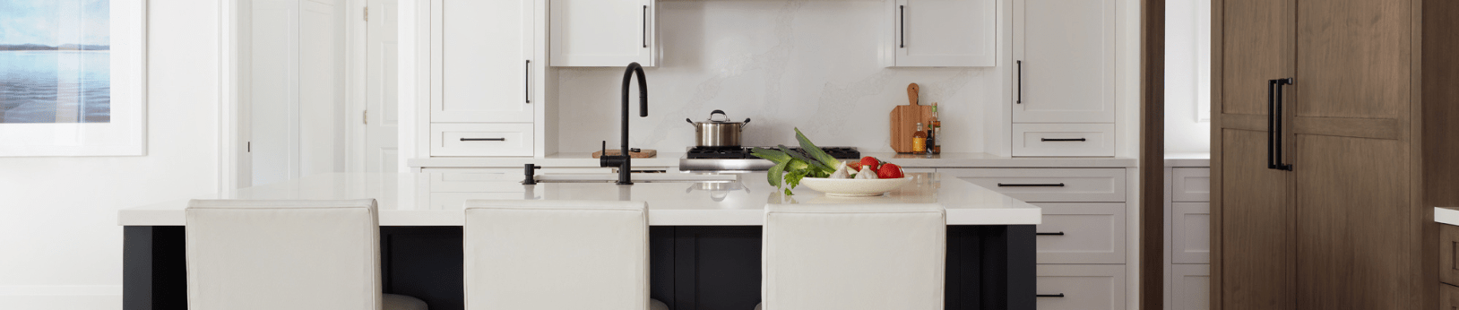 Transitional white painted kitchen with dark painted island and maple wood