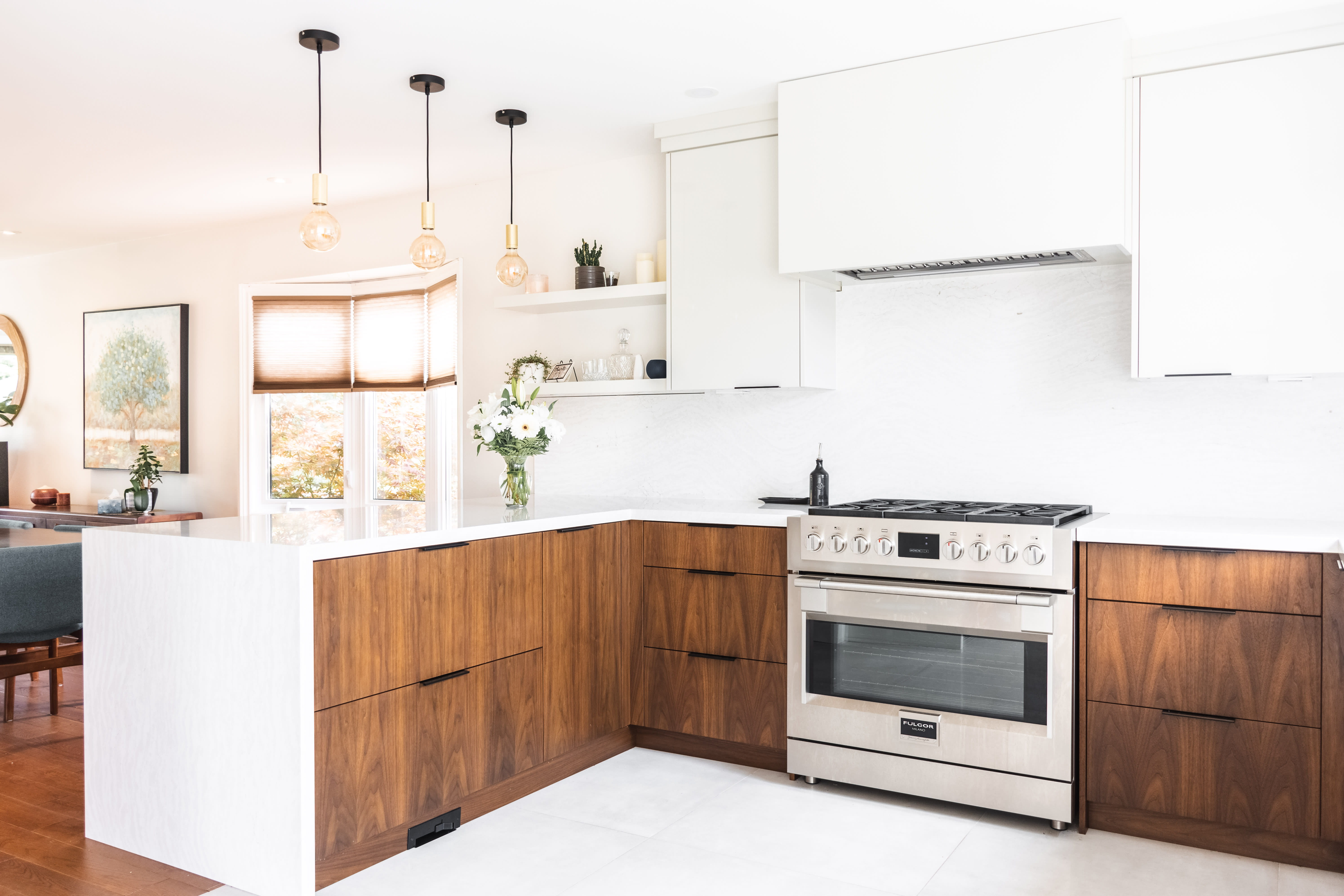 A modern fresh and bright contemporary kitchen with flat-cut walnut wood and high gloss laminate.