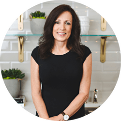 A headshot image of our cabinetry designer catherine heasman, smiling in a black blouse