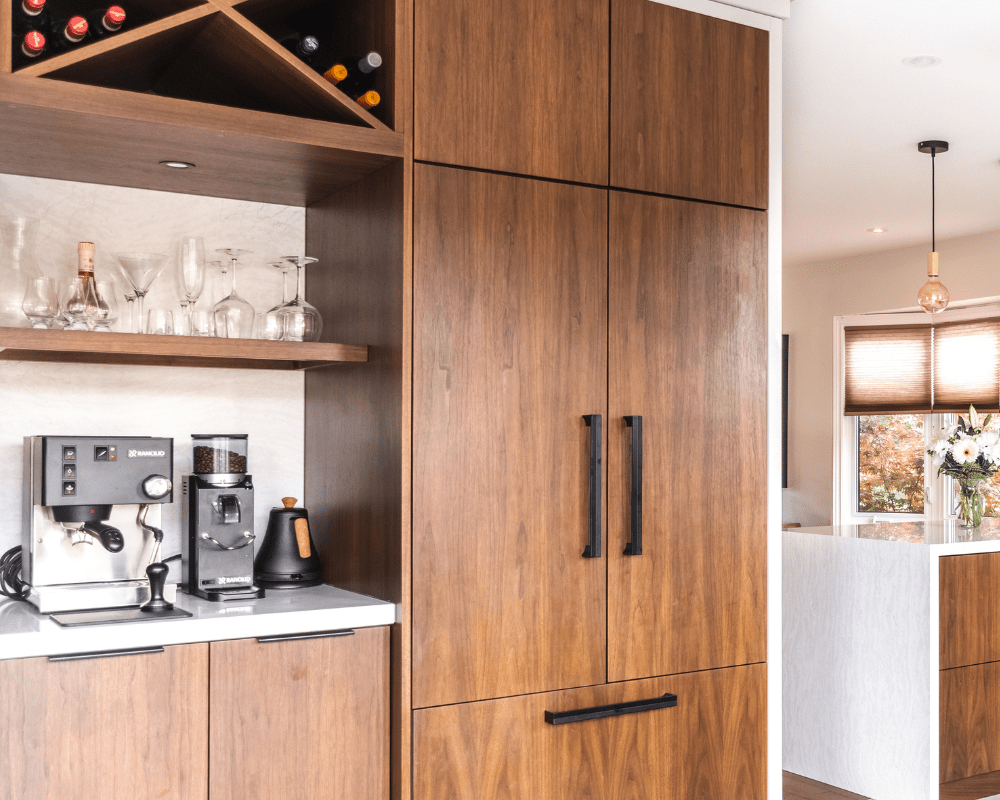 Coffee and wine bar station beside walnut panelled fridge and freezer