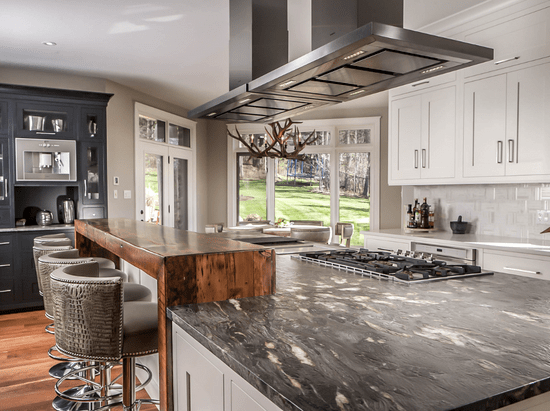 Custom kitchen island with gas range stove and bar-height seating