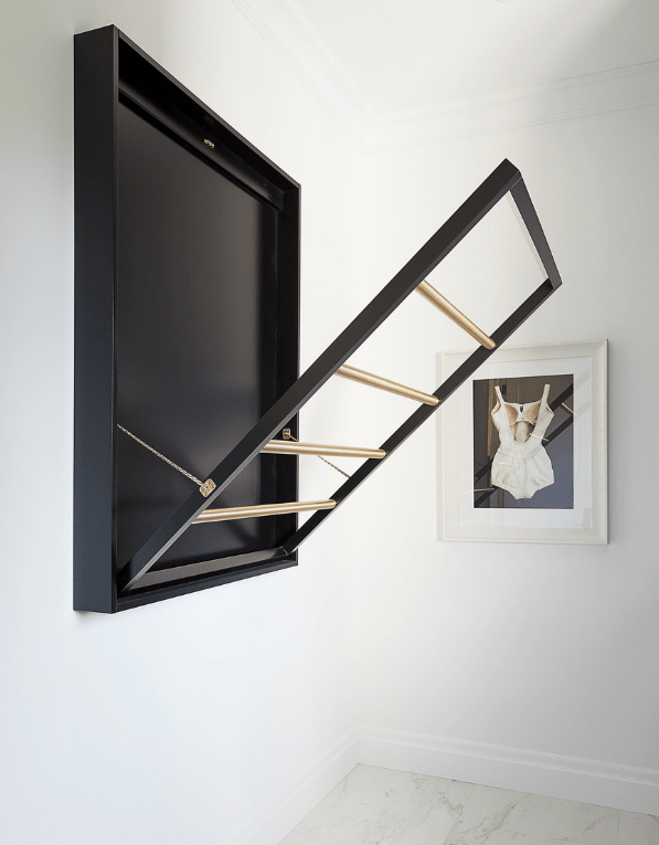 Luxury laundry room with custom black and gold drying rack