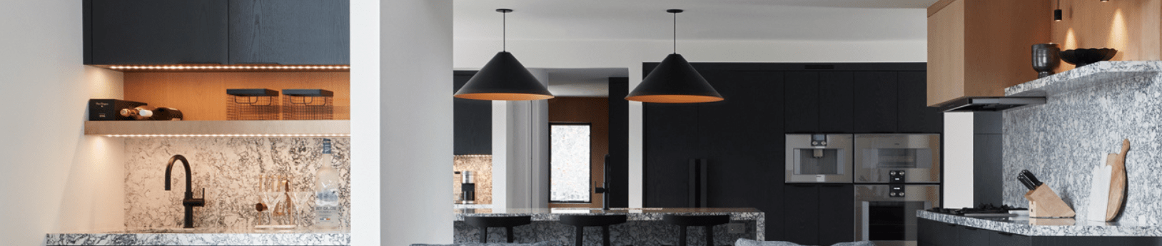 Modern kitchen with black painted cabinetry and natural rift oak accents 