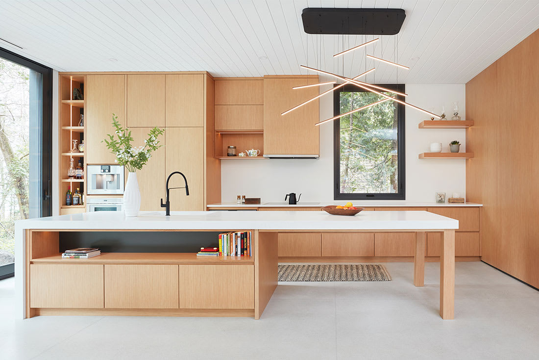 Sleek and modern kitchen with white oak cabinetry and large island with open shelves