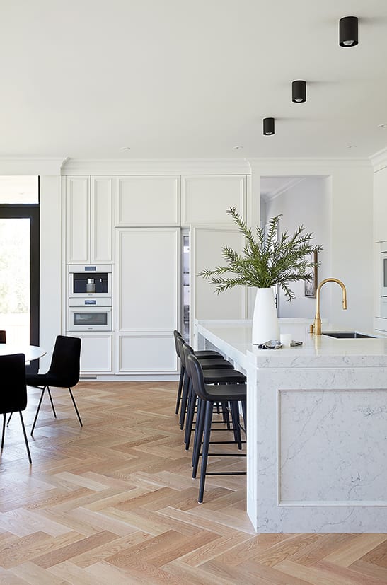 White panel cabinetry with hidden fridge behind