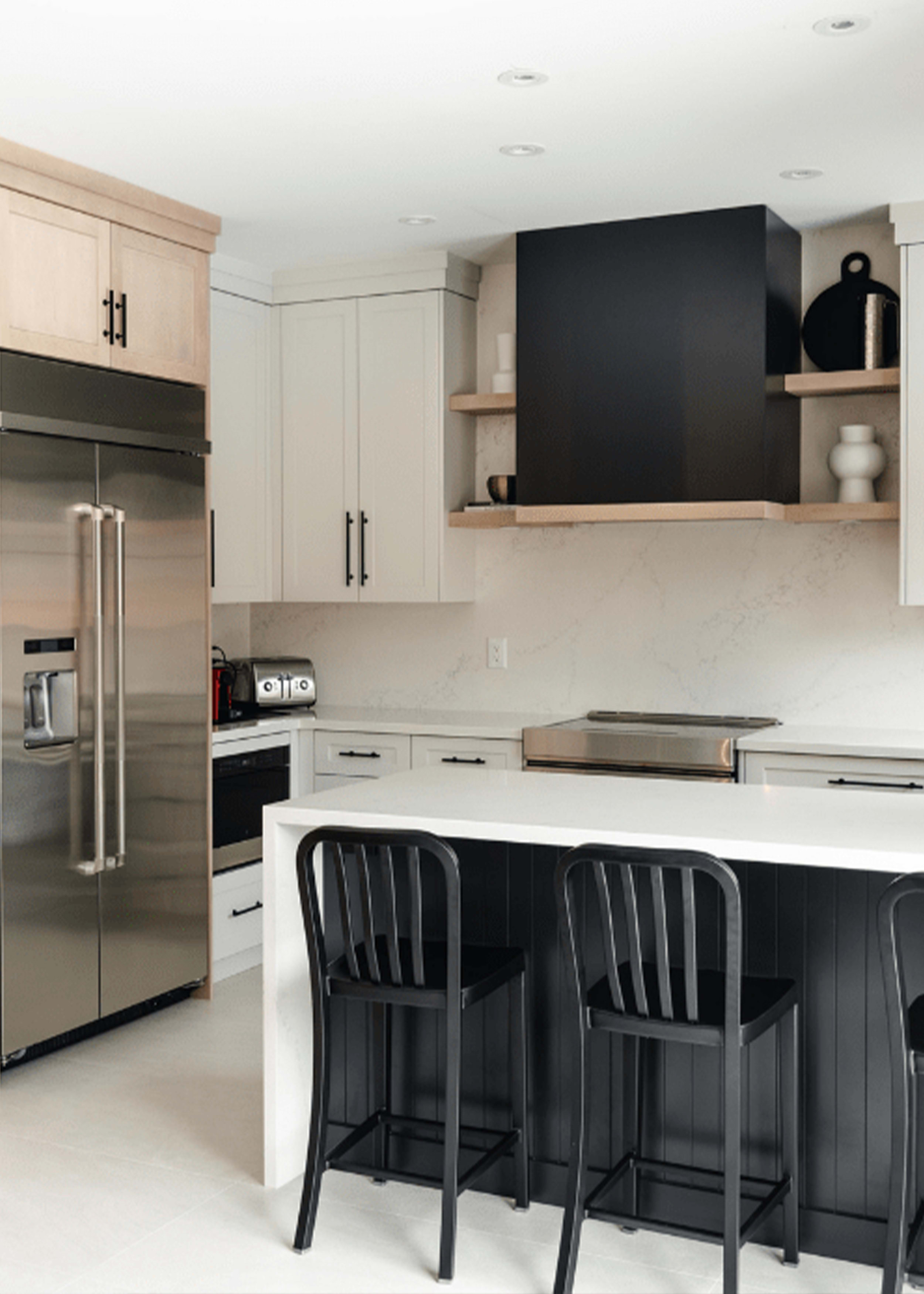 Transitional kitchen with light gray, black, and maple shaker style cabinetry