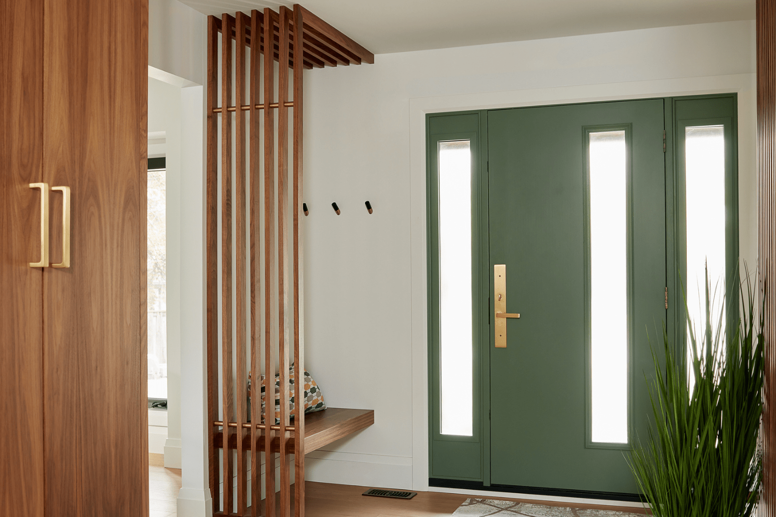 Mid-century modern living room with slated accent wall and floating entry bench