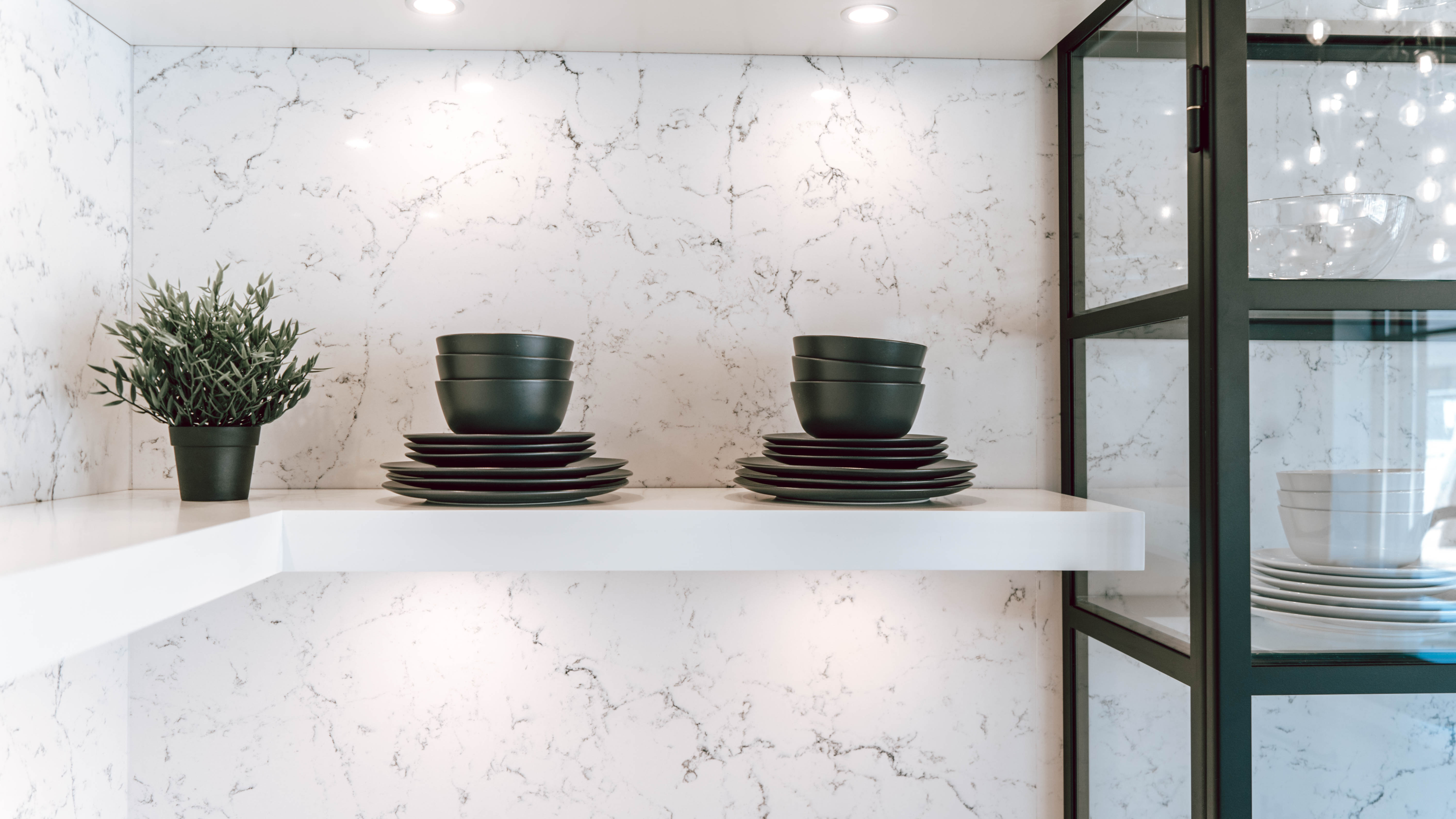 Chervin Kitchen & Bath Oakville - black and white transitional kitchen with display cabinets and floating shelves