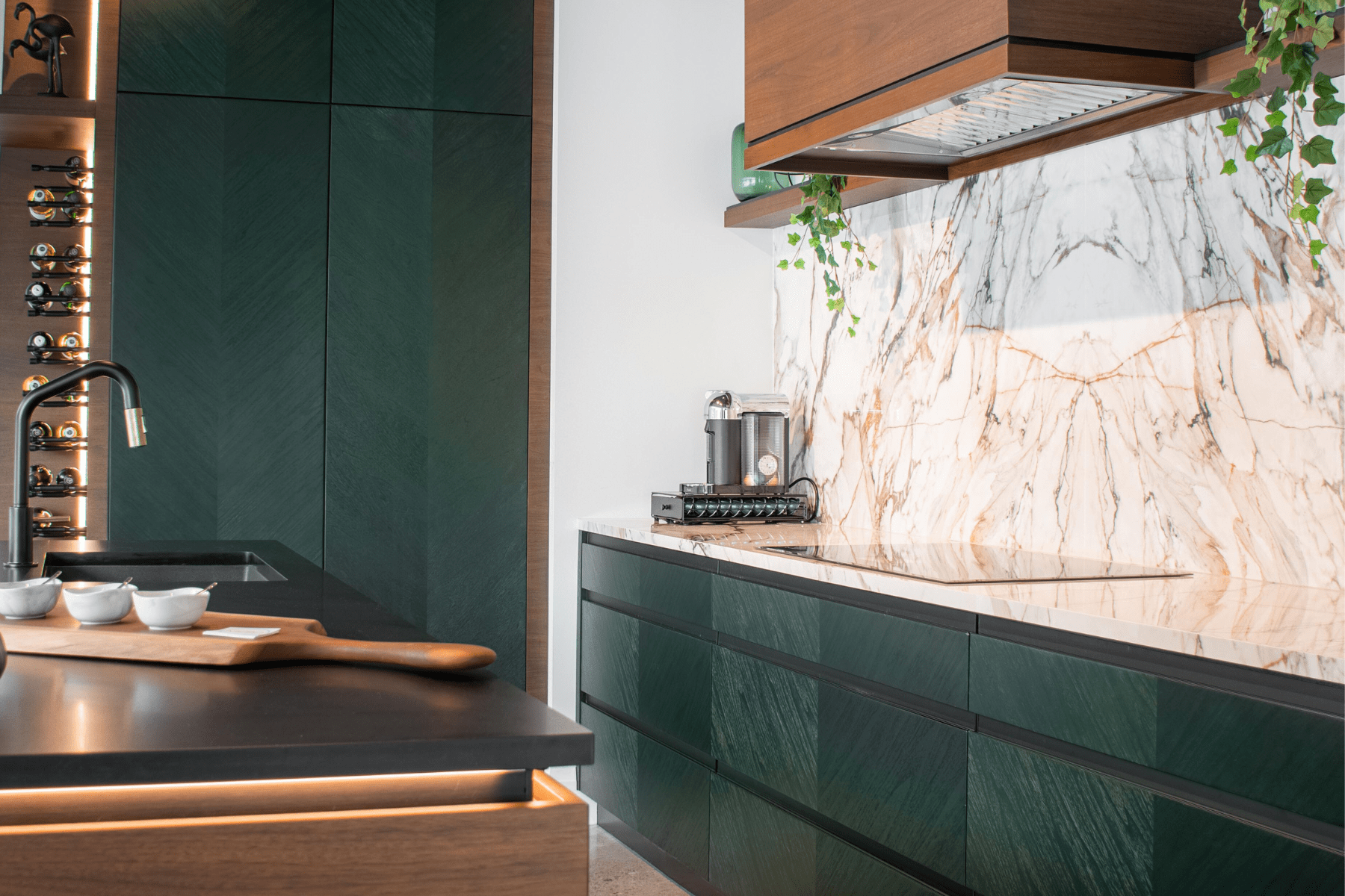 A modern custom kitchen with green stained walnut and hazelnut stained walnut wood.