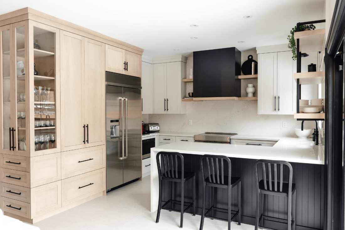 A custom transitional kitchen designed with white, black, and stained maple cabinetry.