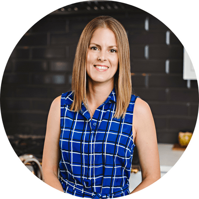 A headshot image of our cabinetry designer paula lang, smiling in a blue blouse