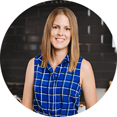 A headshot image of our cabinetry designer paula lang, smiling in a blue blouse