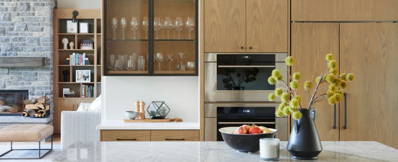 Modern white oak kitchen with view of the great room with white oak built-ins