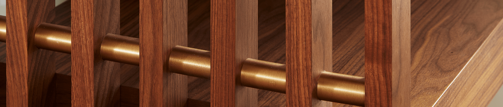 Slatted walnut accent wall with brass rod in mid century modern home renovation