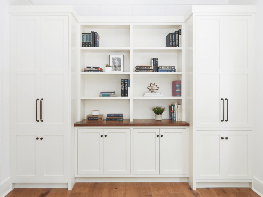 Custom home office wall unit with white cabinetry