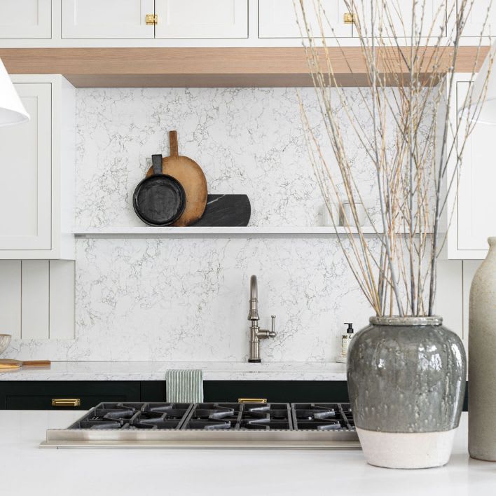 Full height white marbled kitchen backsplash. 