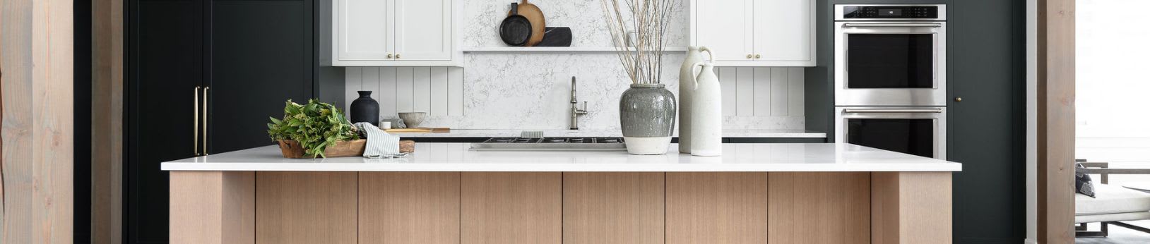 modern black and white rift oak kitchen with waterfall countertop