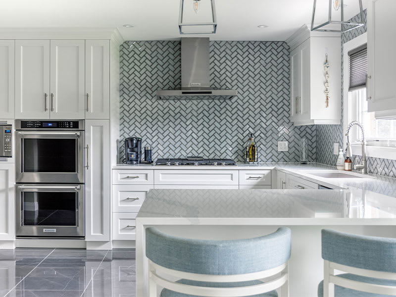 Transitional white cabinet kitchen with an overview of the granite island seating