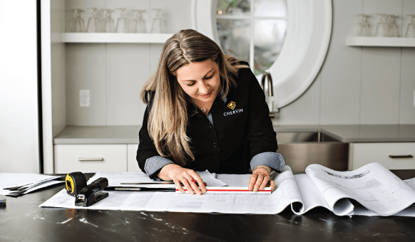 woman working on custom kitchen drawings