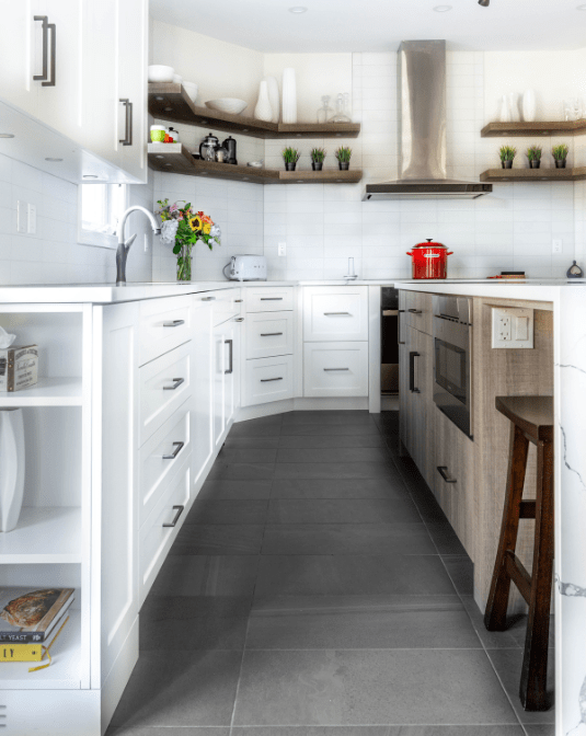 custom kitchen island with integrated applianced and tuck away seating area