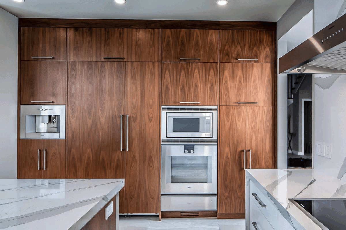 A warm modern wood kitchen with a fixed shelf panrty
