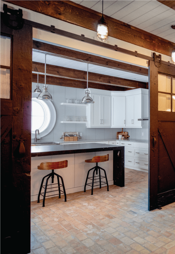 black and white kitchen showroom with barnboard doors