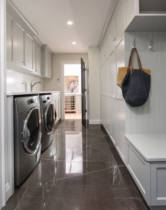 luxurious grey laundry room with grey storage cabinets