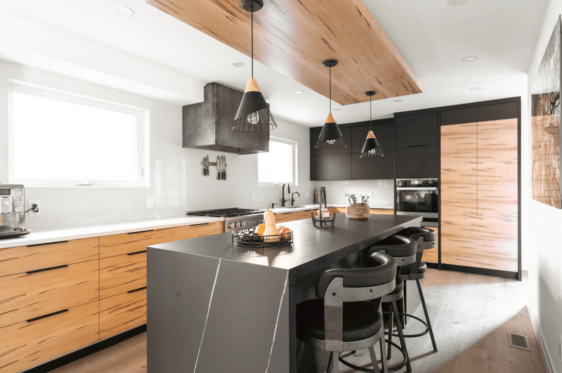 A rustic modern custom kitchen with wormy maple wood and matte black cabinetry. 