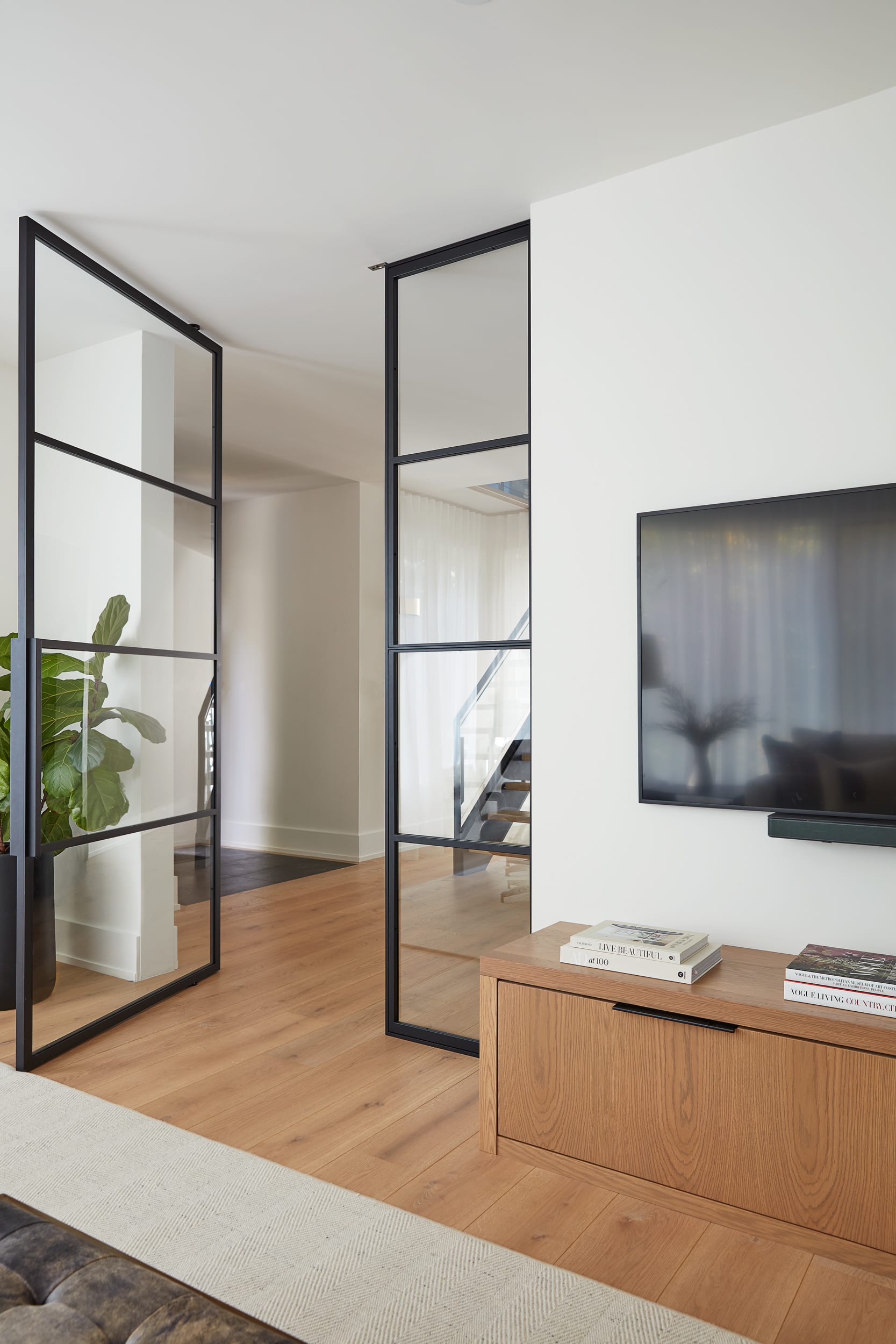 A living room with a white oak console cabinet