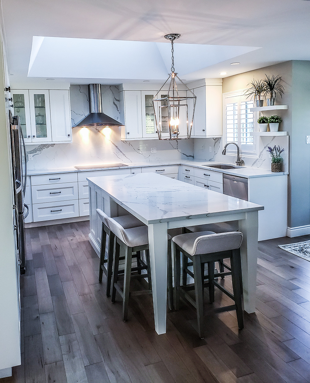 white kitchen with island and floating shelves